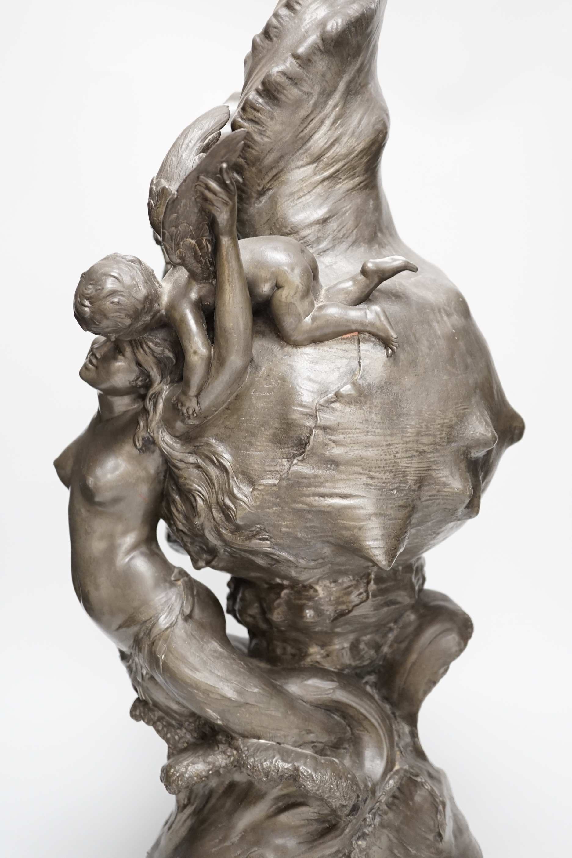 After H. Francois Moreau, a large spelter group of Cupid and a mermaid before a giant conch shell, signed, 64cm high